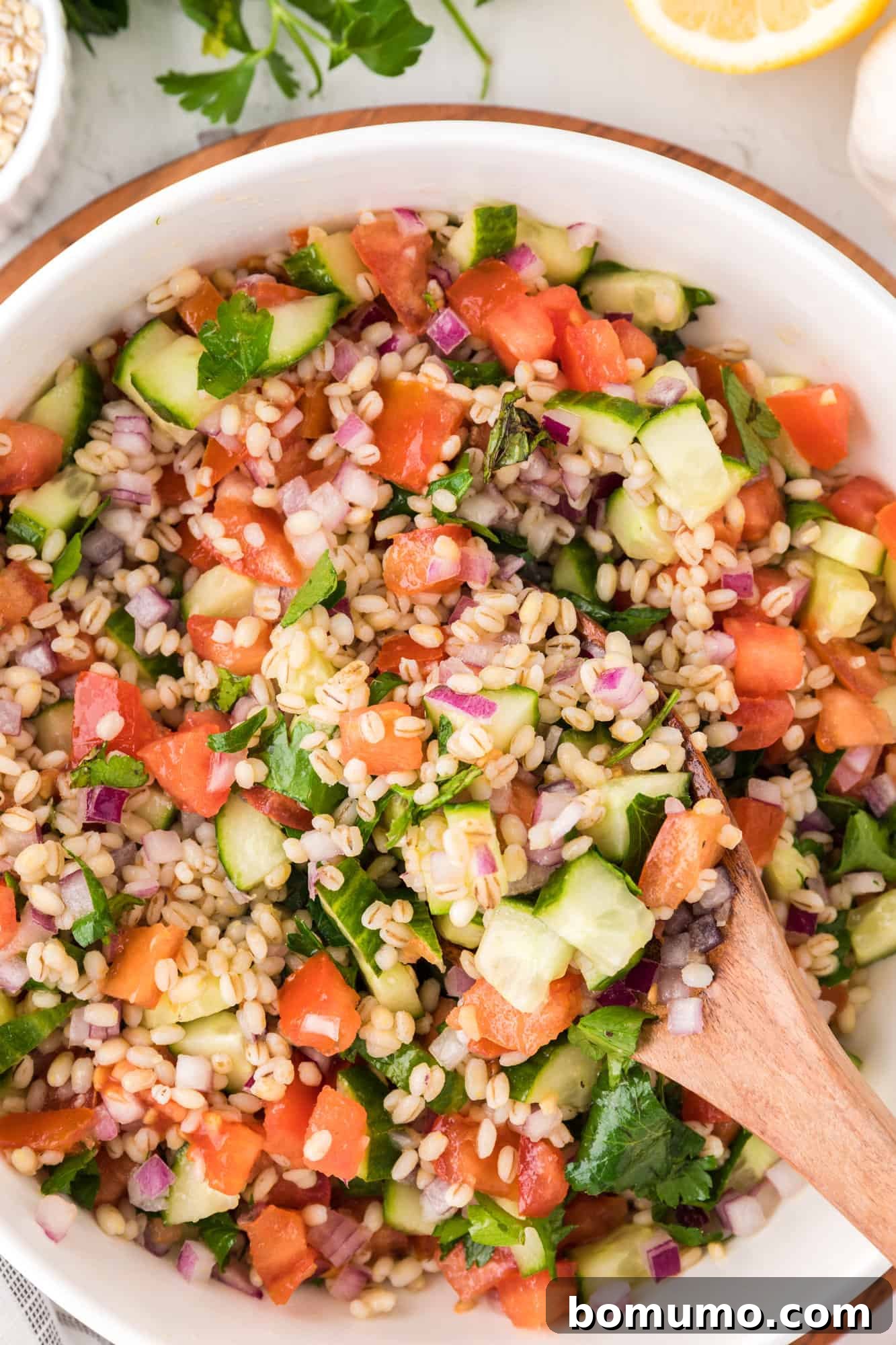 Barley salad with tomatoes, cucumbers, onions.
