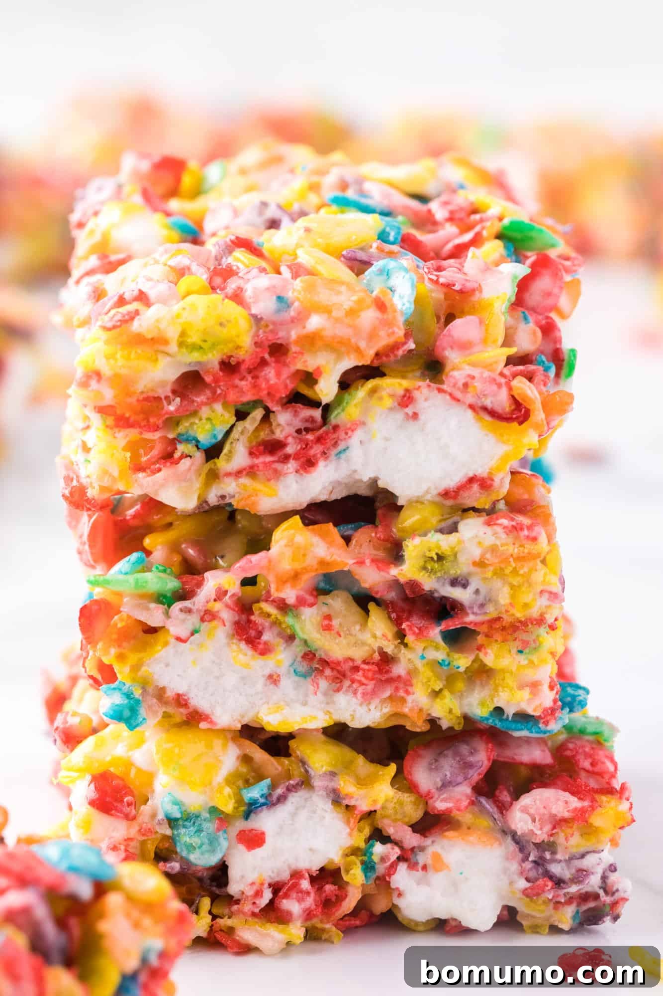 Close up of a stack of three Fruity Pebbles treats.