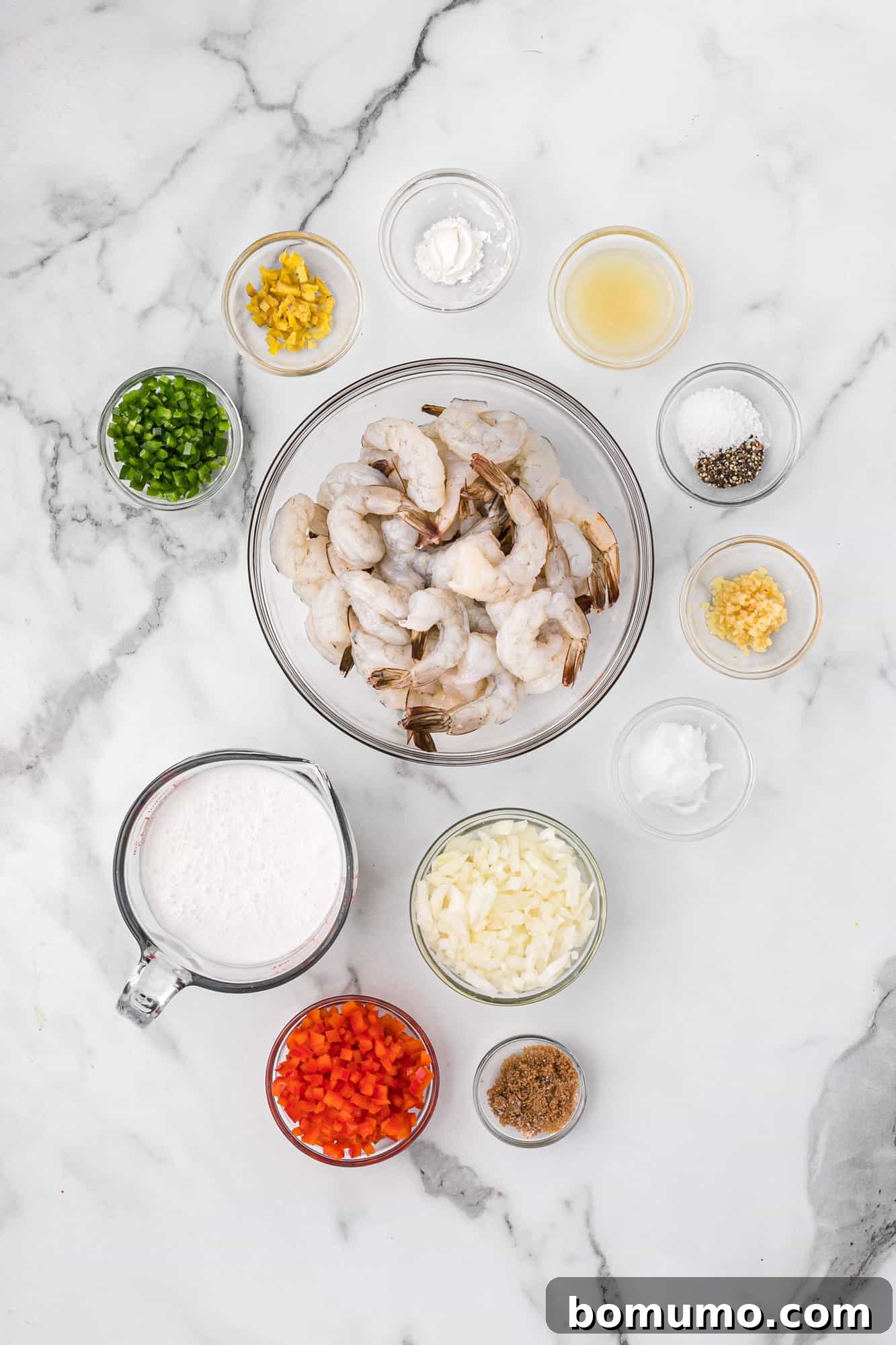 All the fresh ingredients laid out, including vibrant shrimp, colorful peppers, and fragrant aromatics, ready for cooking.