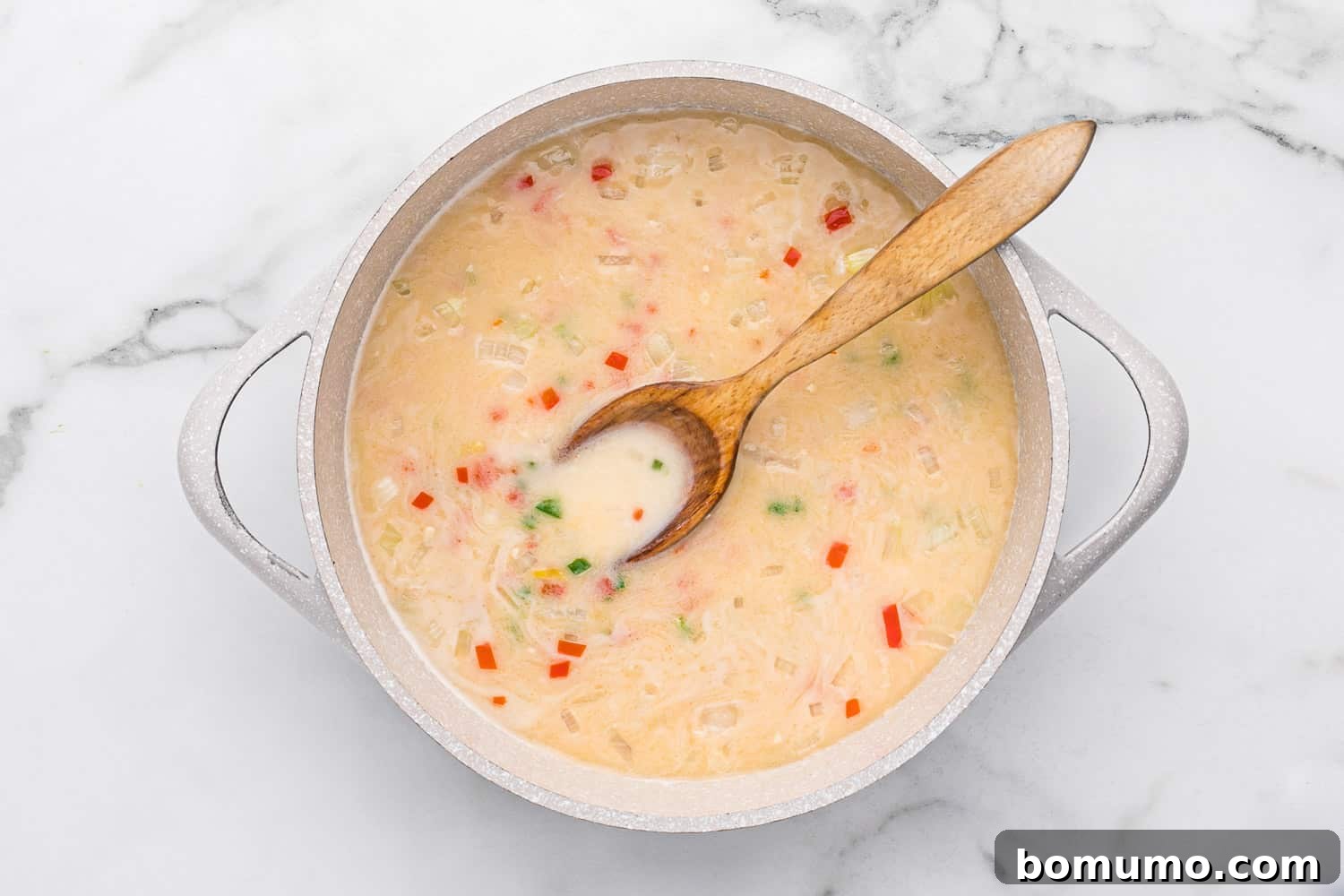 Fresh lime juice stirred into the simmering coconut sauce.