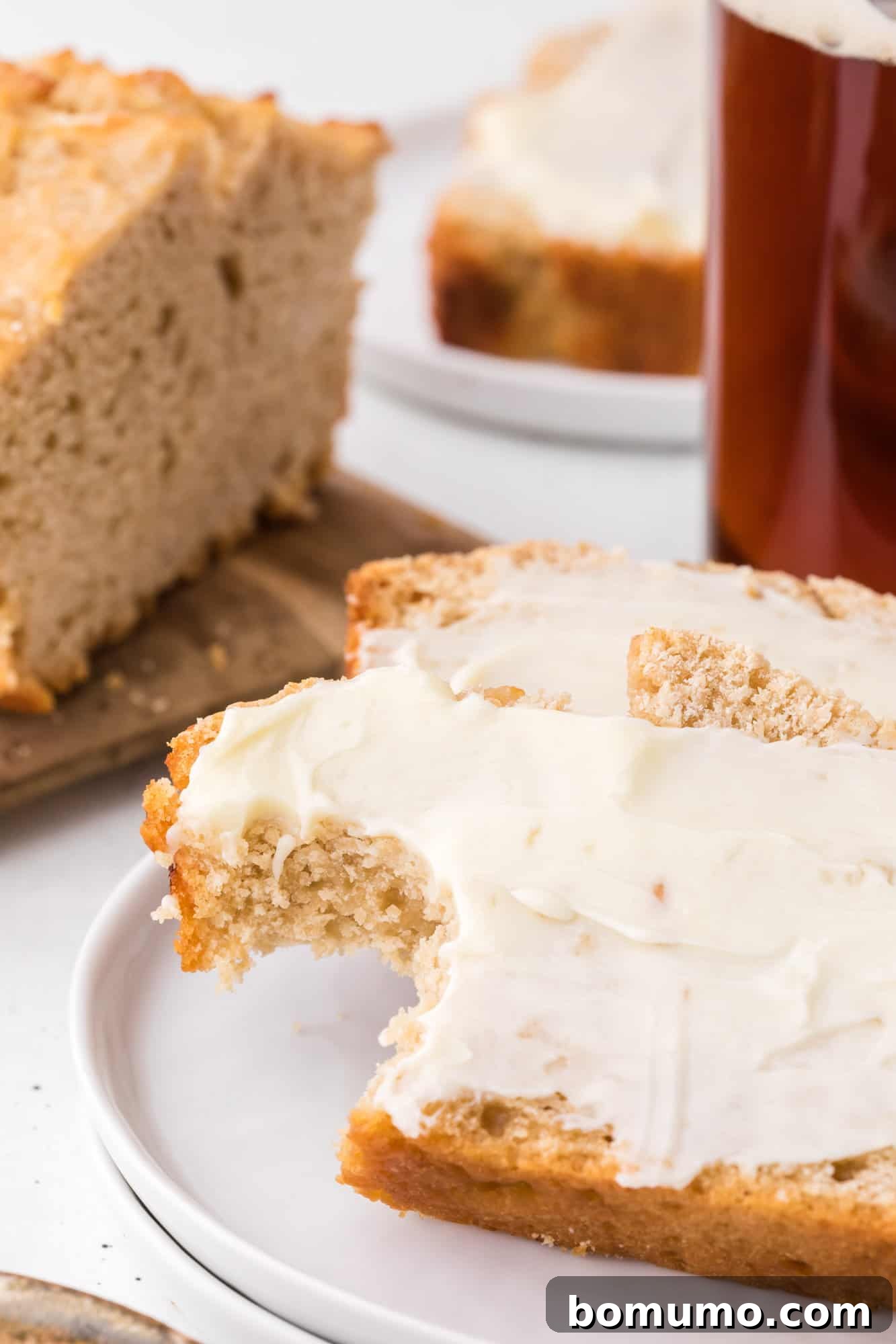 Beer bread with butter and a bite taken out.