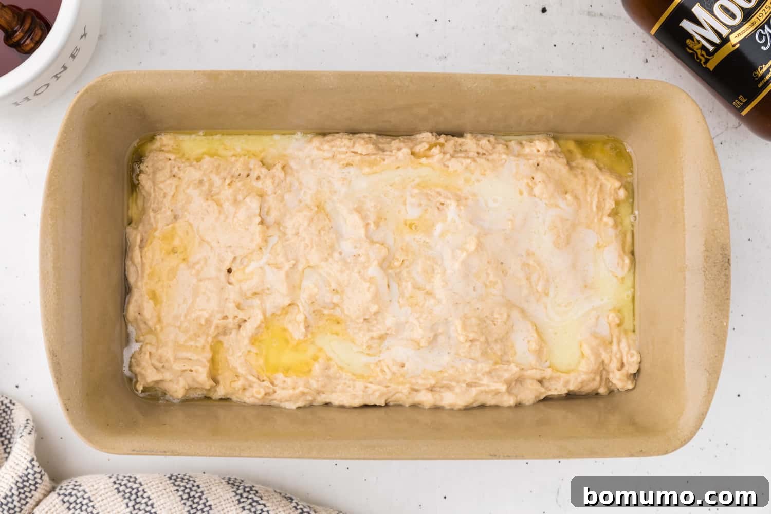 Butter poured over unbaked bread.
