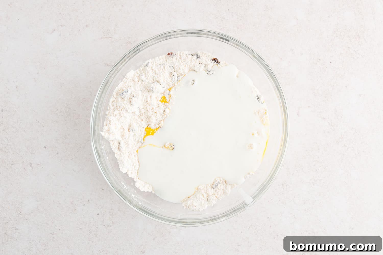 Wet ingredients, egg and buttermilk, added to the dry dough mixture.