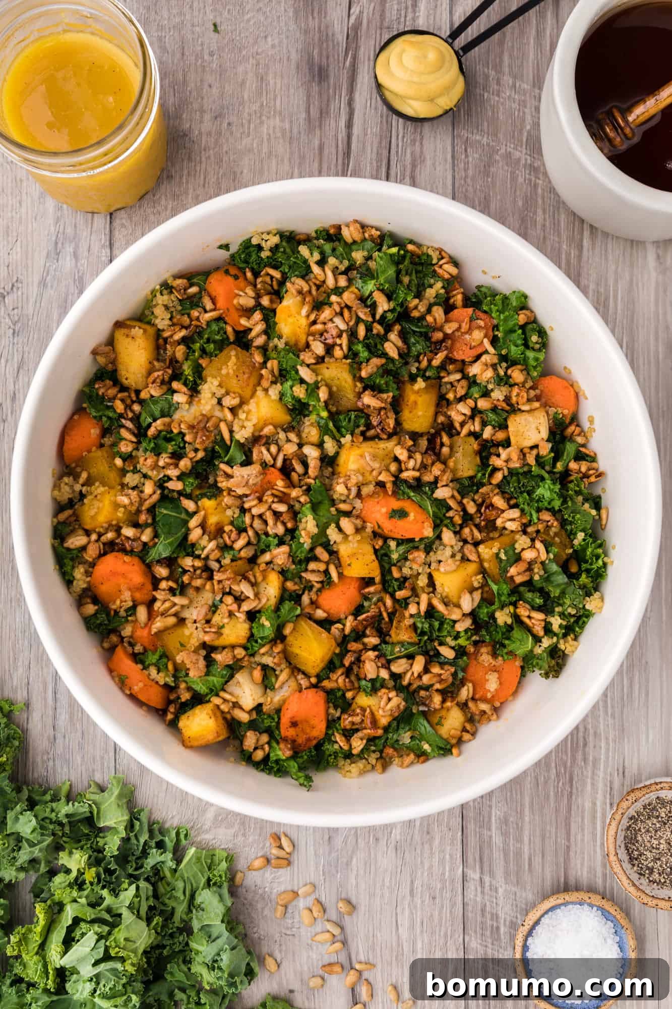 An overhead shot of the beautifully plated warm kale salad, showcasing its vibrant colors and textures.