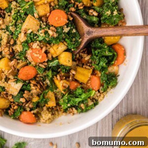 Warm kale salad with quinoa and candied sunflower seeds.