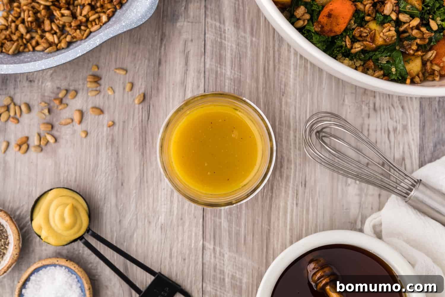 Homemade honey mustard vinaigrette in a small glass jar.