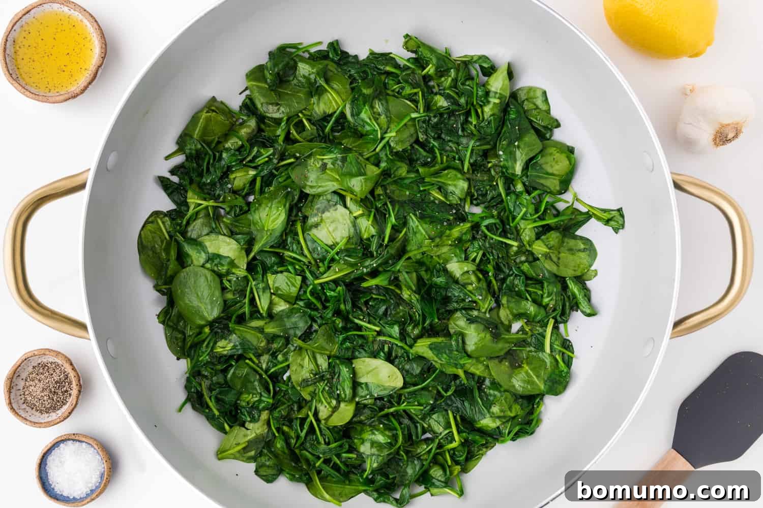 Pan-Seared Spinach Sensation 6 Perfectly sautéed spinach, now wilted and reduced in volume within a large skillet, ready for final touches.