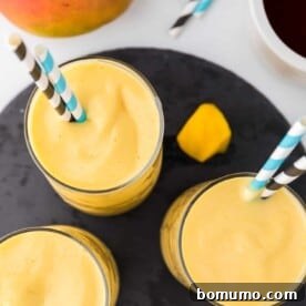 Overhead view of three mango smoothies.