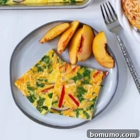 Sheet pan eggs served on a plate with fresh peaches.