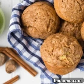 Overhead view of muffins in a basket with blue and white linen.