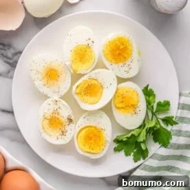 Plate of boiled eggs with pepper and parsley.
