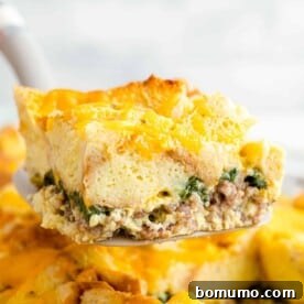 Breakfast casserole being scooped from casserole dish.