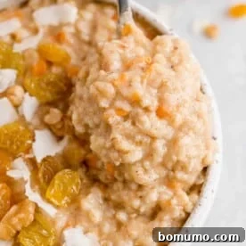 Carrot cake oatmeal with raisins and coconut on top.