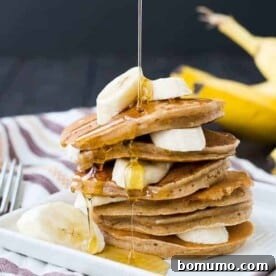 These easy and healthy banana pancakes taste just like banana bread in a whole wheat pancake form! They freeze well and will make mornings delicious! Get the healthy pancake recipe on RachelCooks.com!