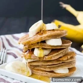 A stack of healthy whole wheat banana pancakes, perfectly golden brown and ready for syrup.