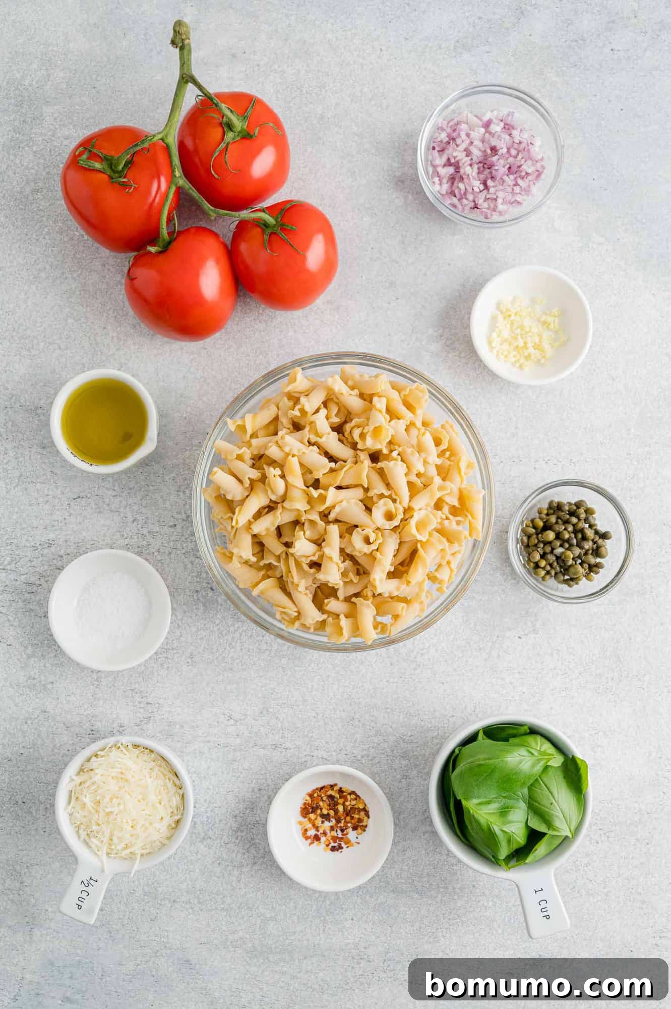 The ingredients for fresh tomato pasta with basil.