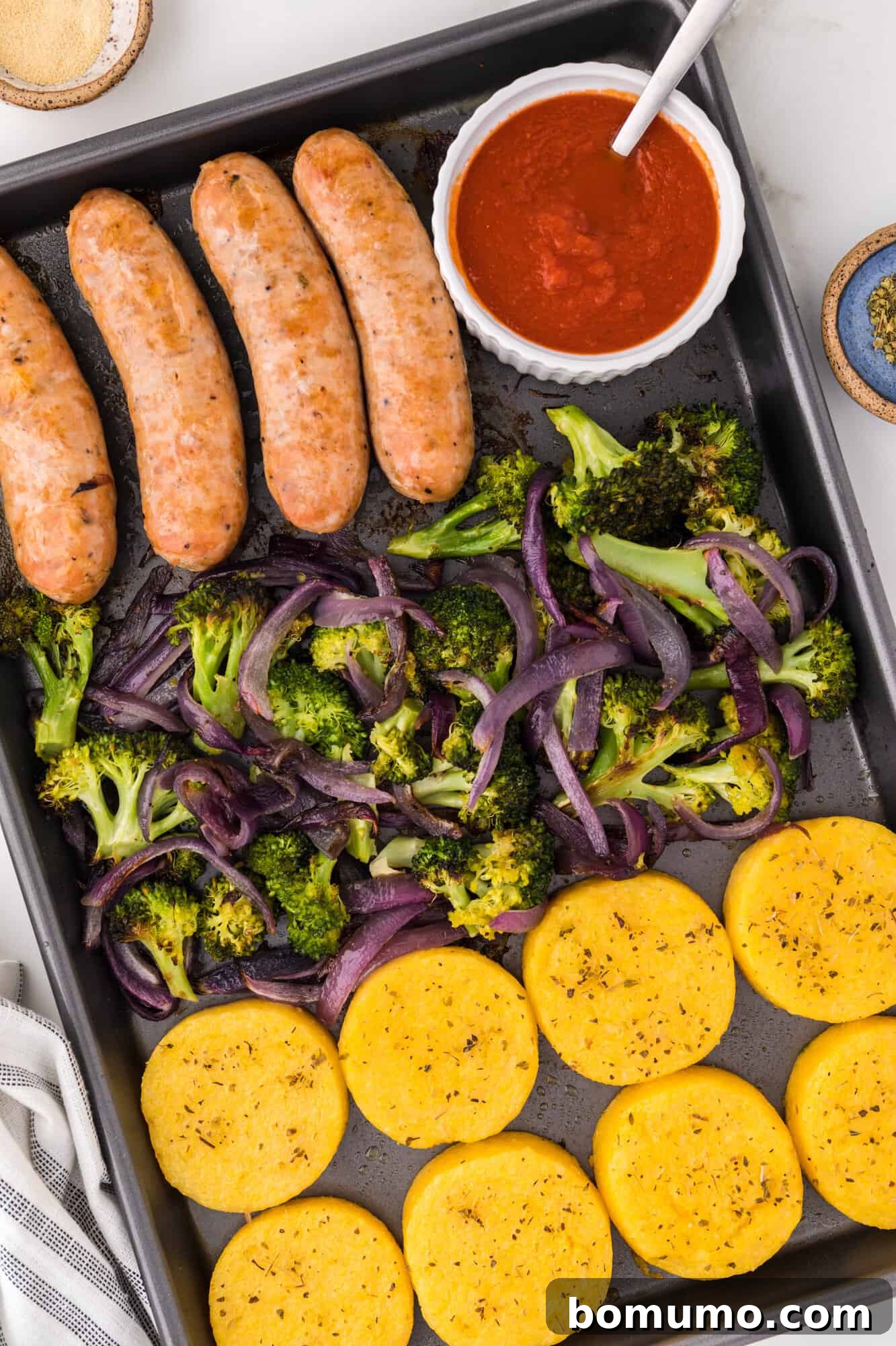Sheet pan with Italian sausage, broccoli, and polenta.