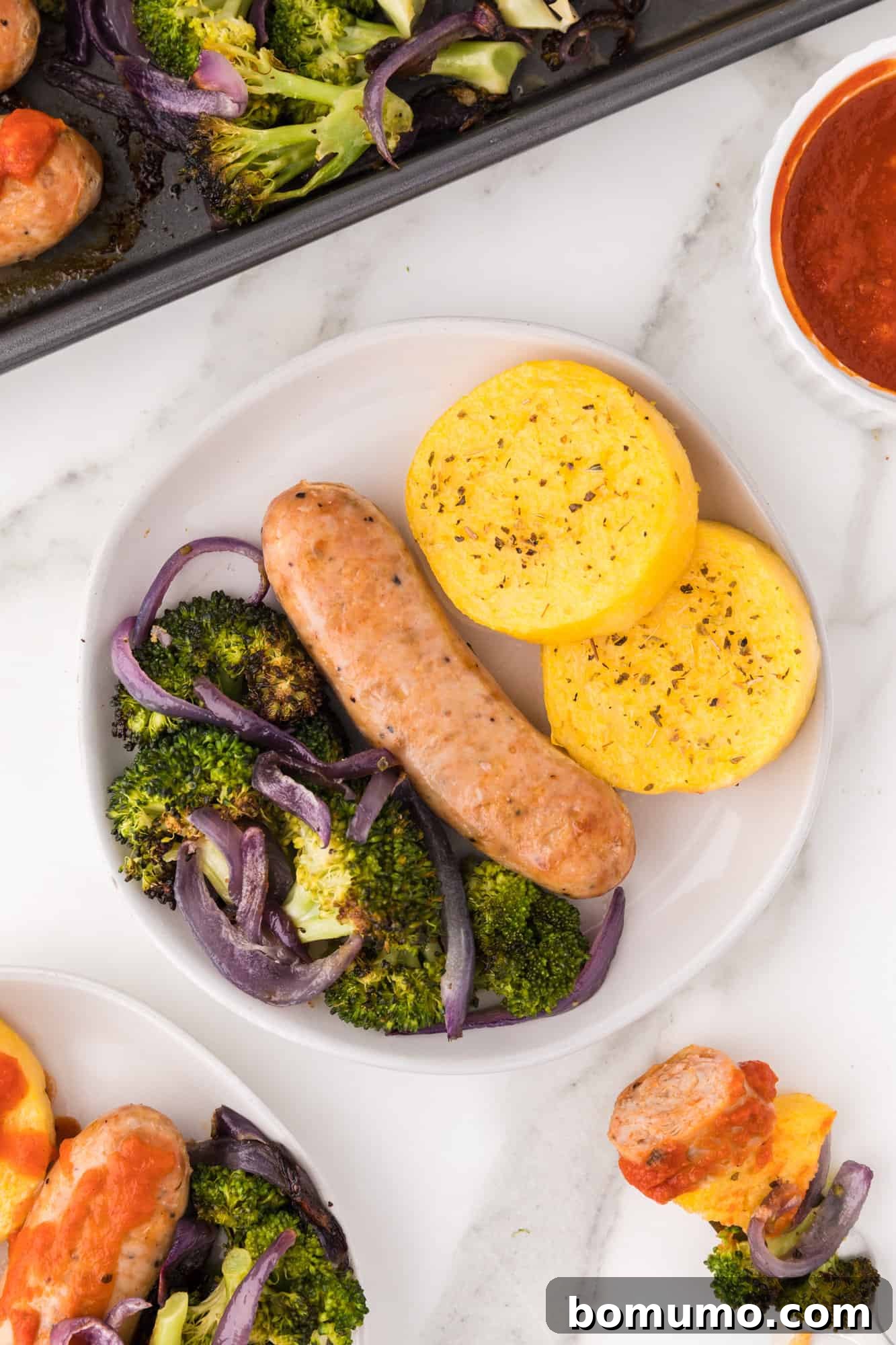 Plated recipe with sausage and polenta.