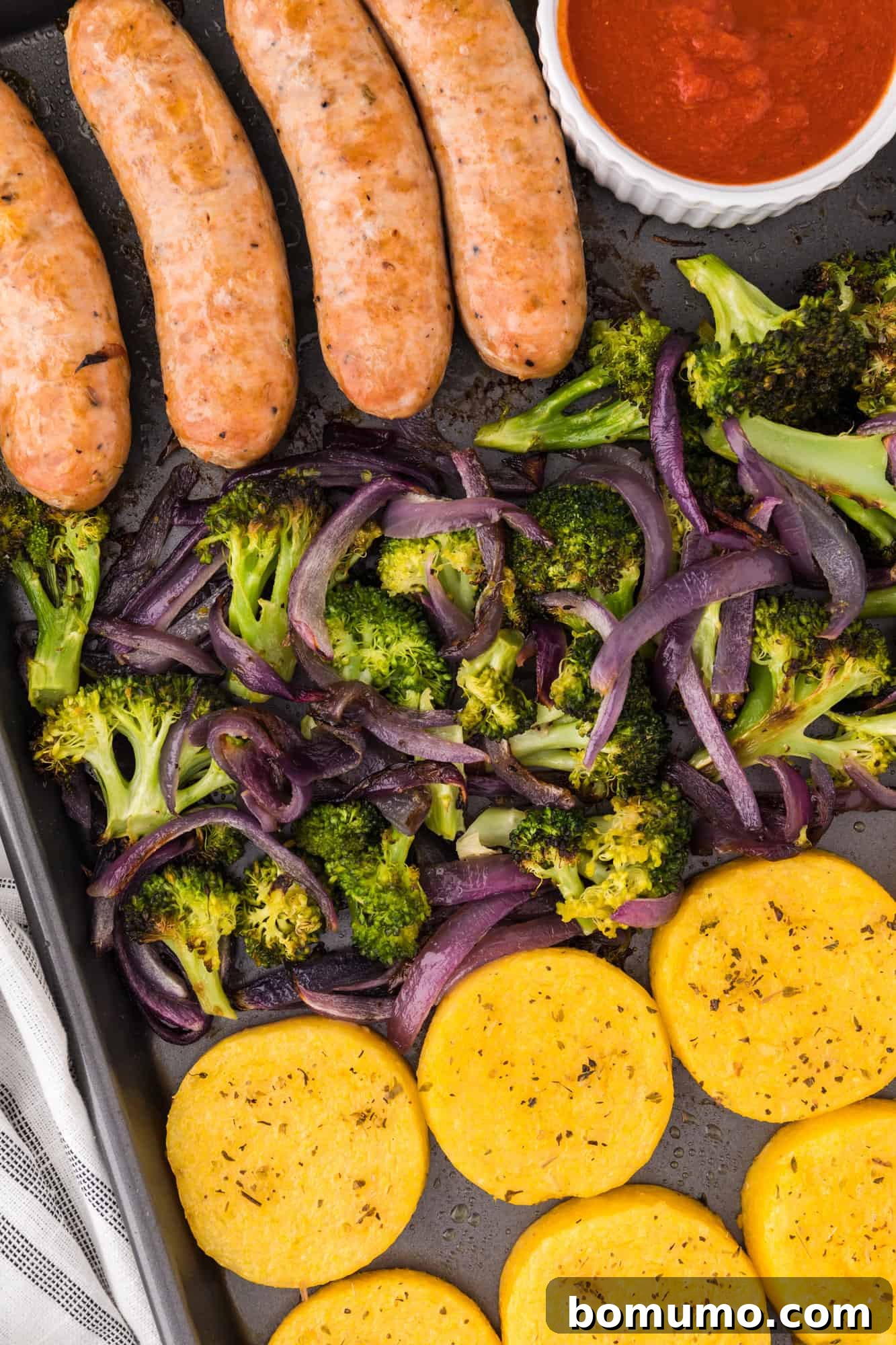 Completed sheet pan meal with marinara.
