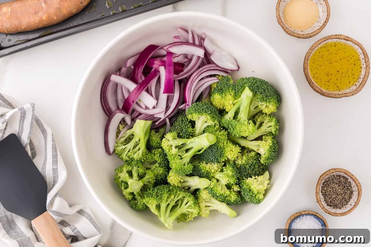 Broccoli and onions in bowl not yet mixed.