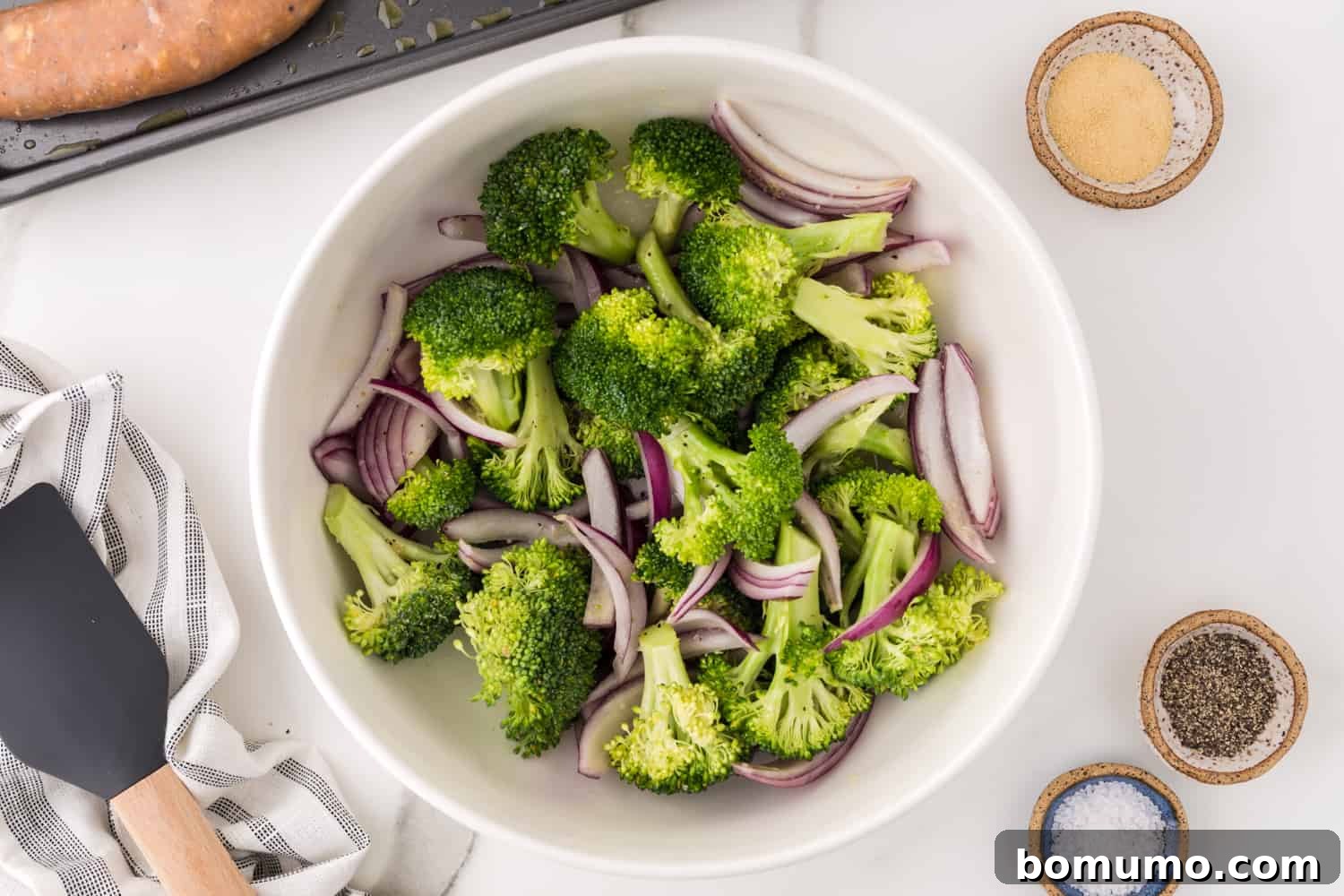 Broccoli and onion mixed with oil and seasonings.