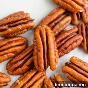 How to toasted pecans post image, pecan halves and a spatula.
