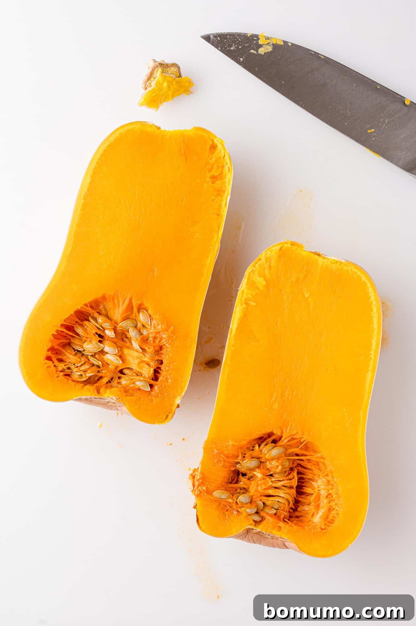 Halved butternut squash, after cooking, revealing its tender, golden flesh.
