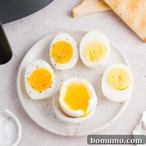 A visual guide to air fryer boiled eggs, showcasing different levels of doneness: soft, jammy, and hard-boiled eggs side-by-side for comparison.