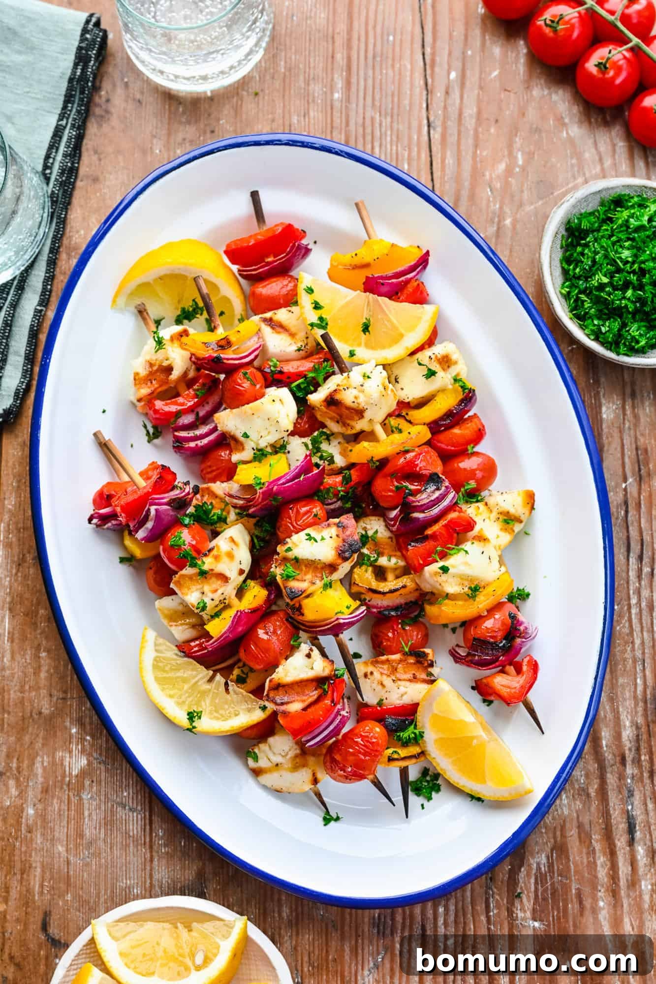 Vegetable and halloumi kebabs on a platter.