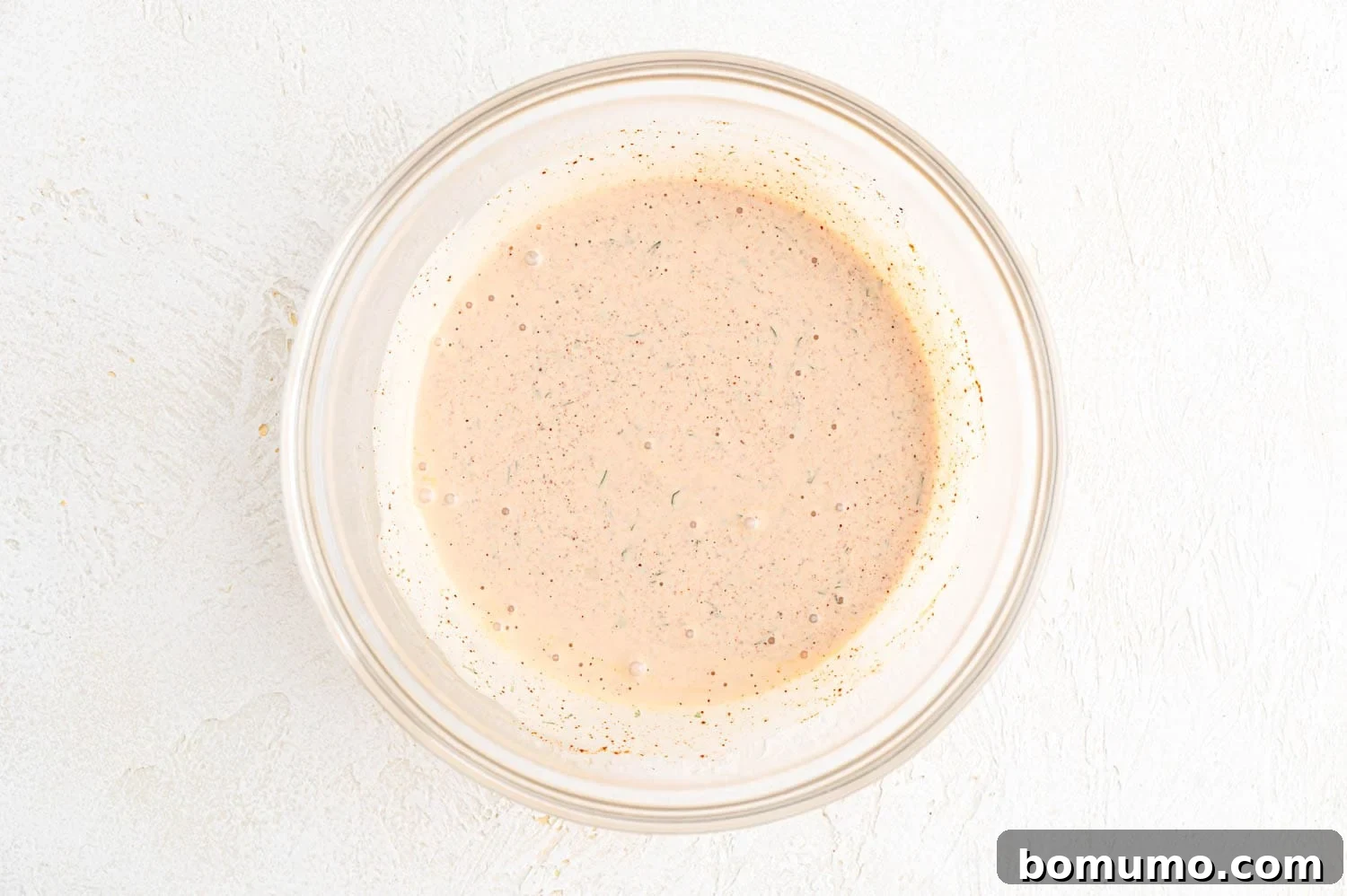The creamy cilantro lime sauce, perfectly mixed and ready to be drizzled over the shrimp tacos.