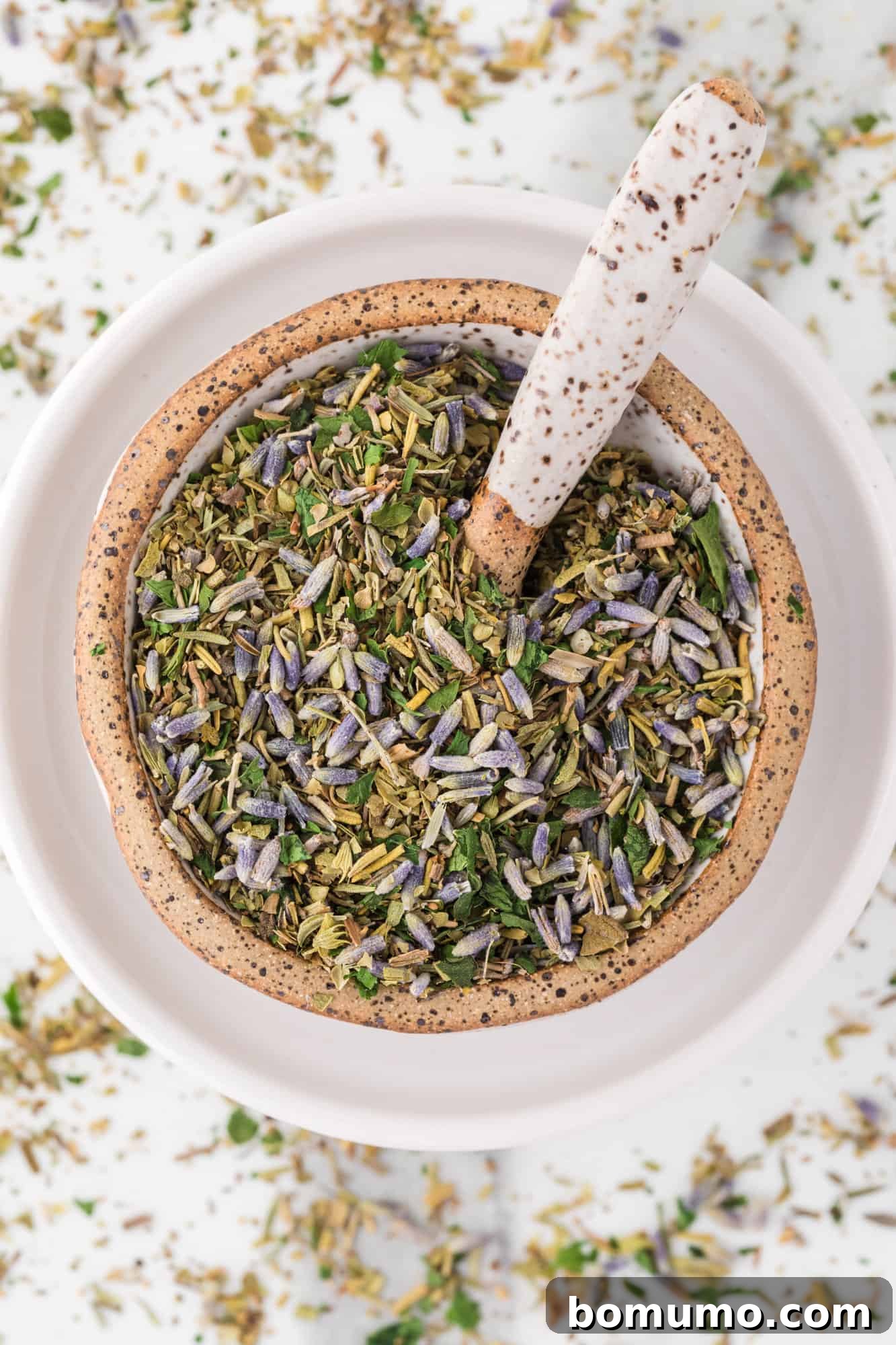 Herbes de Provence in a small bowl with a spoon, ready to be used in cooking.