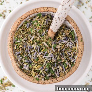Herbes de Provence in a small ceramic bowl, ready for culinary use.