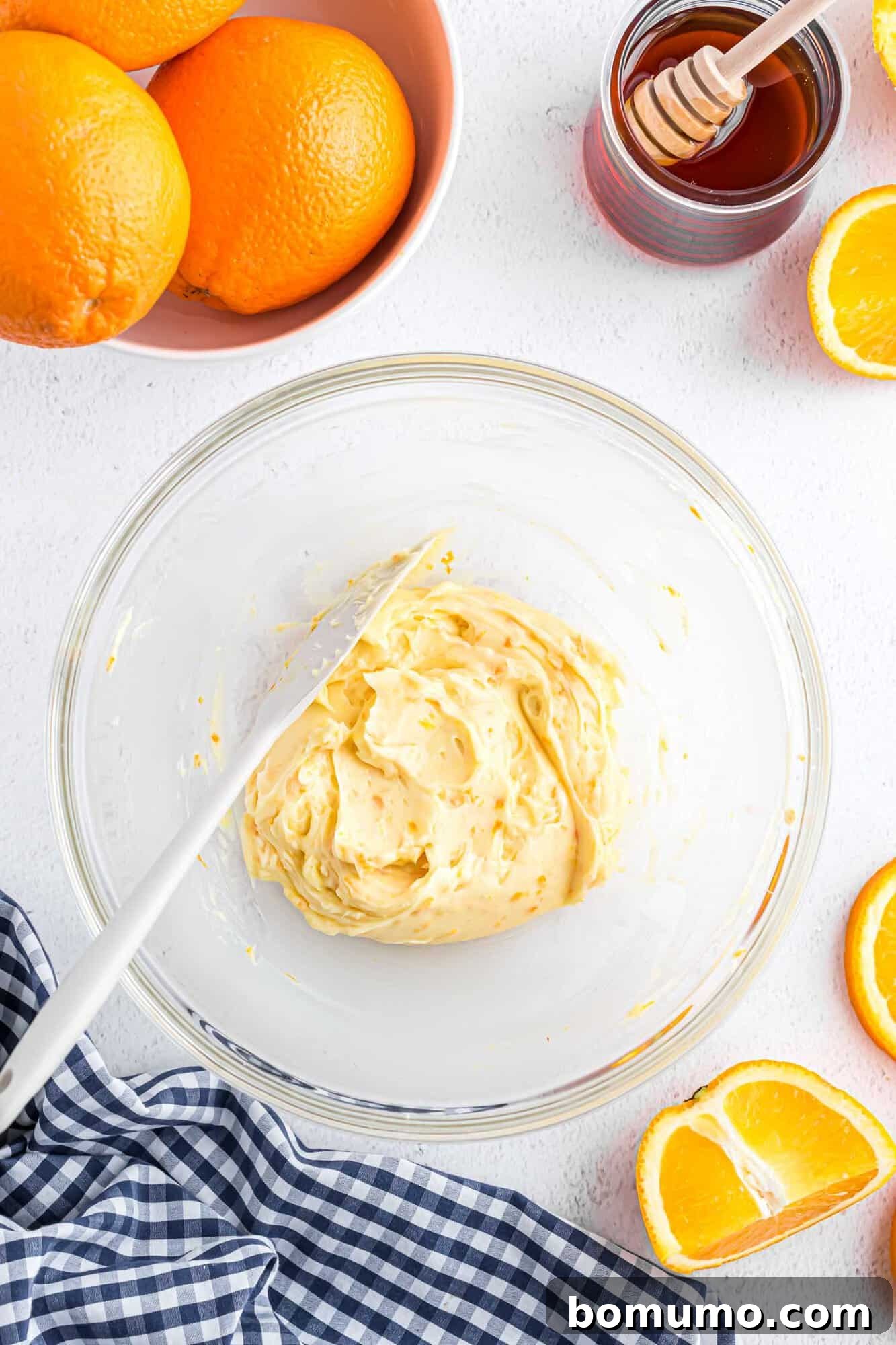 The finished orange honey butter, beautifully blended to a creamy, uniform consistency, presented in a small glass mixing bowl.