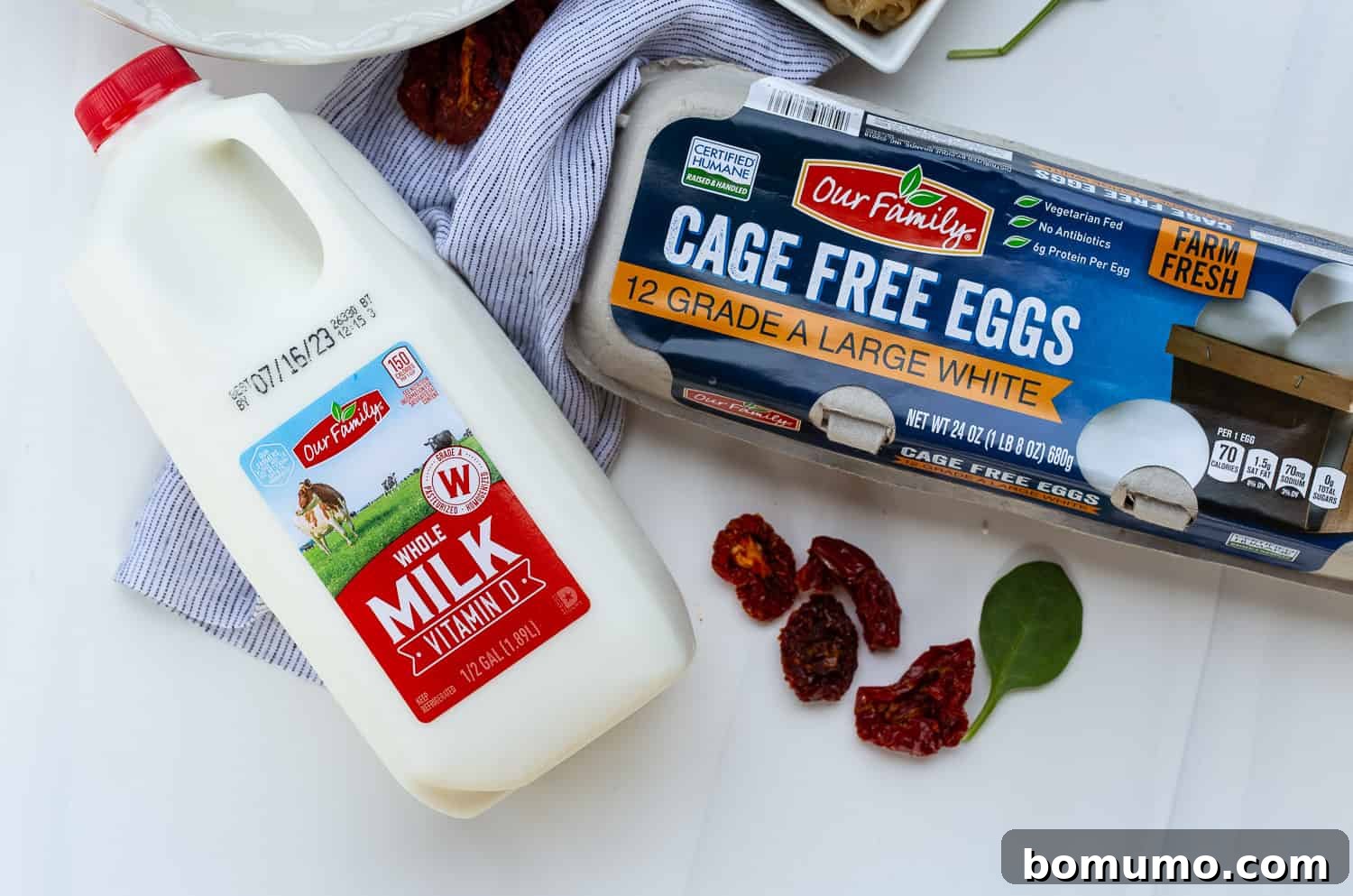 A visual of the essential liquid ingredients: a carton of whole milk and a bowl of fresh large eggs, ready to be combined for the quiche base.