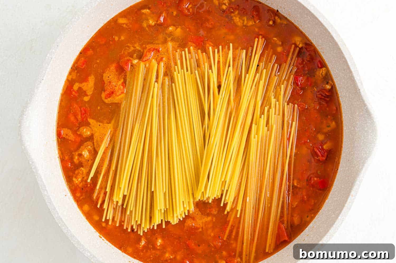 Pasta added to pan.