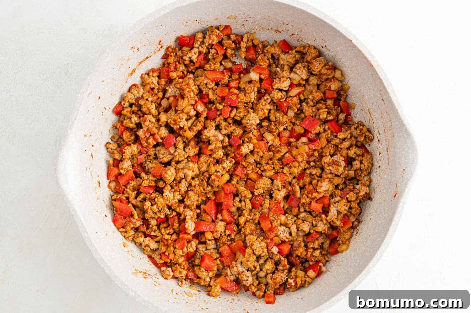 Ingredients coated with spices and tomato paste.