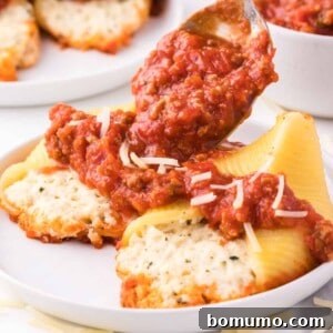 Close-up of a single stuffed shell showcasing the rich meat sauce and melted cheese, ready to be enjoyed.