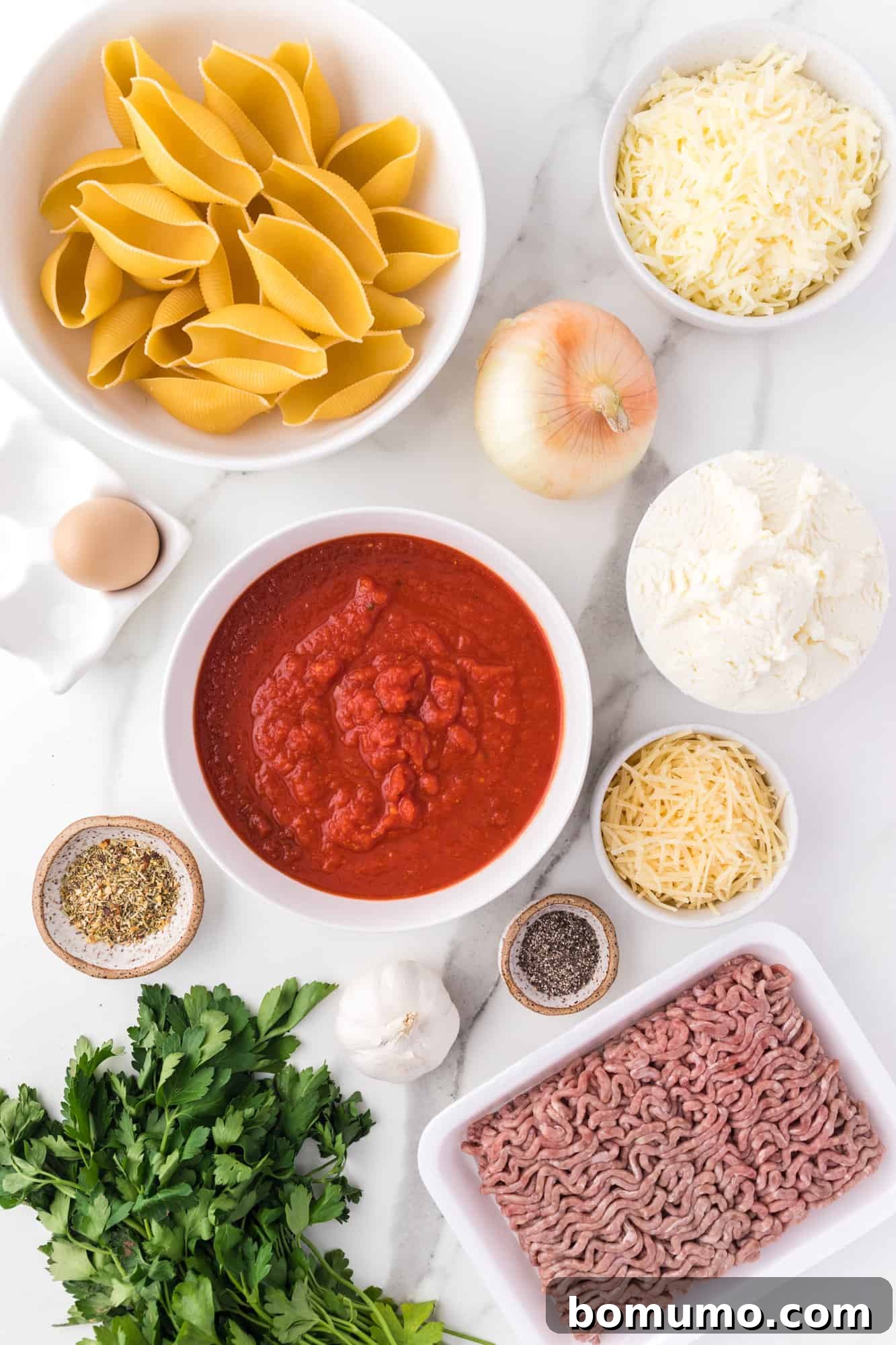 Savory Meat-Filled Jumbo Shells 4 An overhead view capturing all the fresh ingredients meticulously laid out on a clean counter, ready for preparing the delicious stuffed shells recipe.