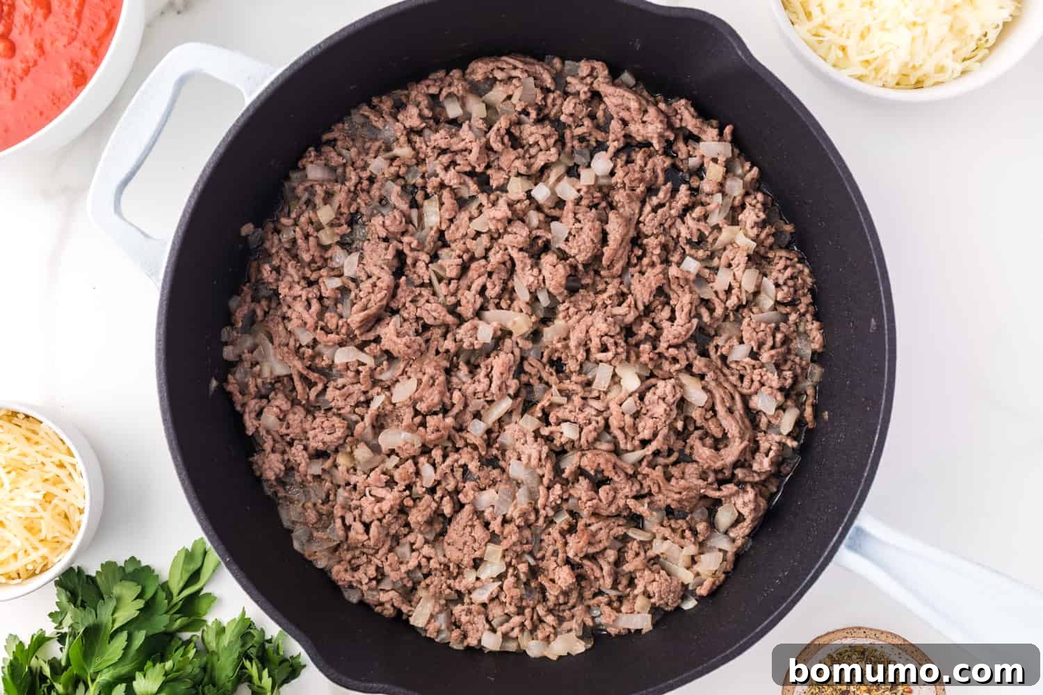 Savory Meat-Filled Jumbo Shells 6 Lean ground beef sizzling and browning in a black skillet, expertly broken apart for an even cook.