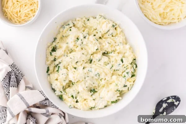 Savory Meat-Filled Jumbo Shells 9 The creamy cheese filling mixture, perfectly combined in a bowl, showing the ricotta, mozzarella, Parmesan, and parsley ready for stuffing.