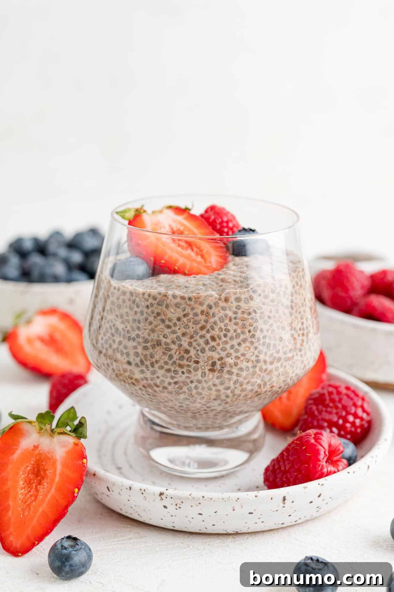 Chia seed pudding topped with fresh fruit like berries and sliced banana.