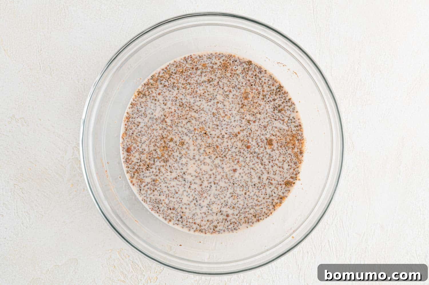 The chia seed pudding ingredients after being mixed together in a bowl.