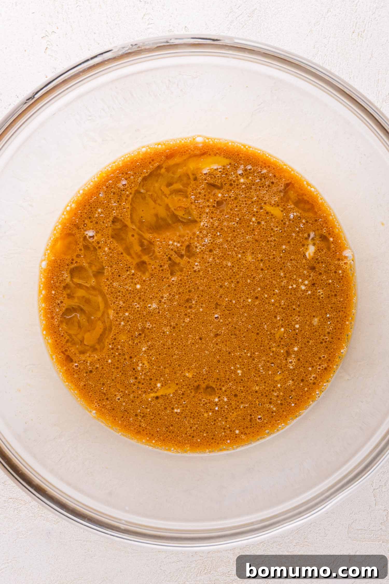 Gingerbread Bliss Pancakes 5 A glass bowl with the wet ingredients for the pancakes.