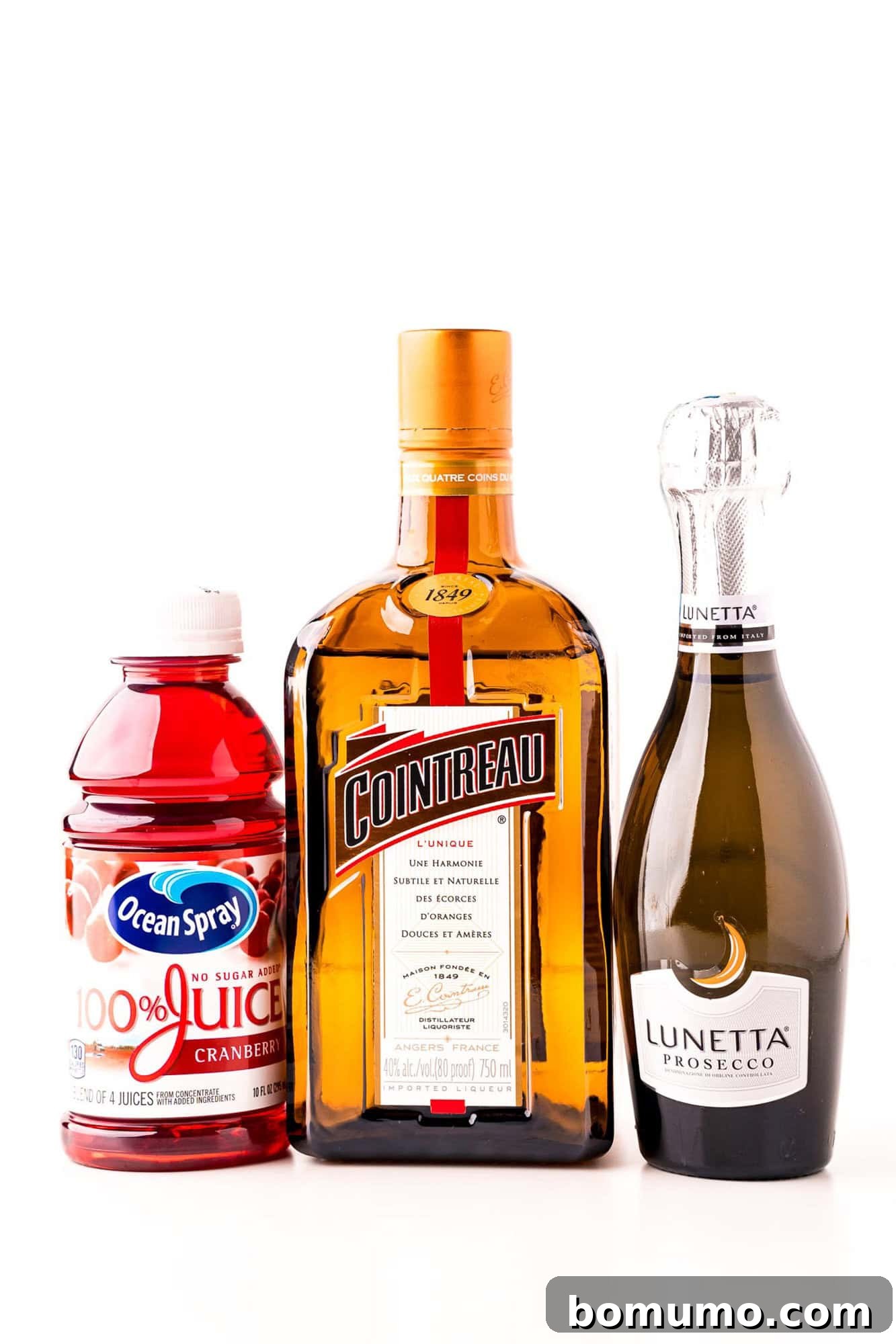 Bottles of cranberry juice, Cointreau, and Lunetta Prosecco lined up.