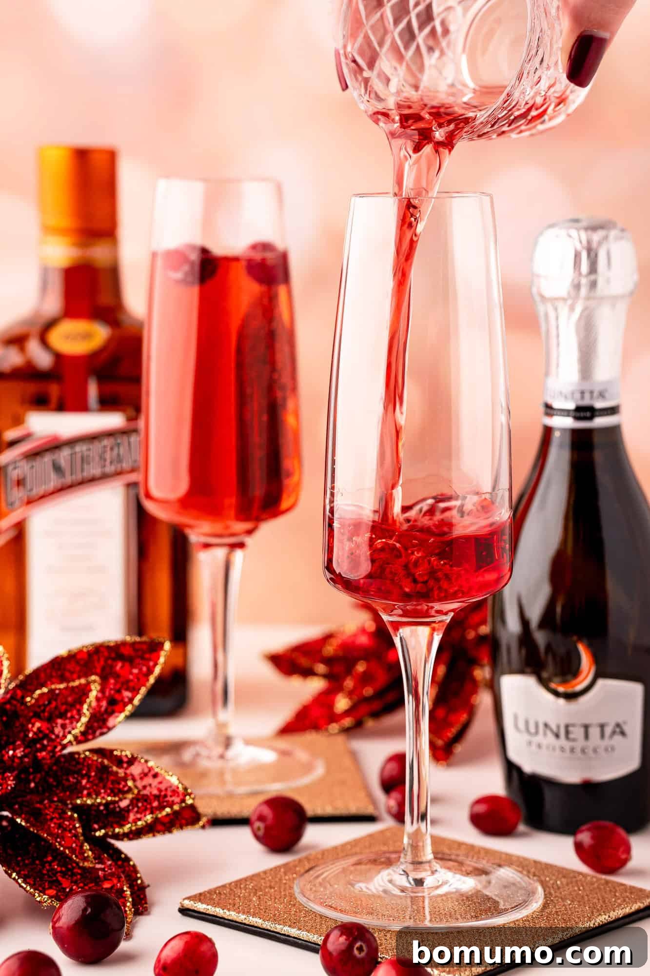 Pouring cranberry juice into a champagne flute.