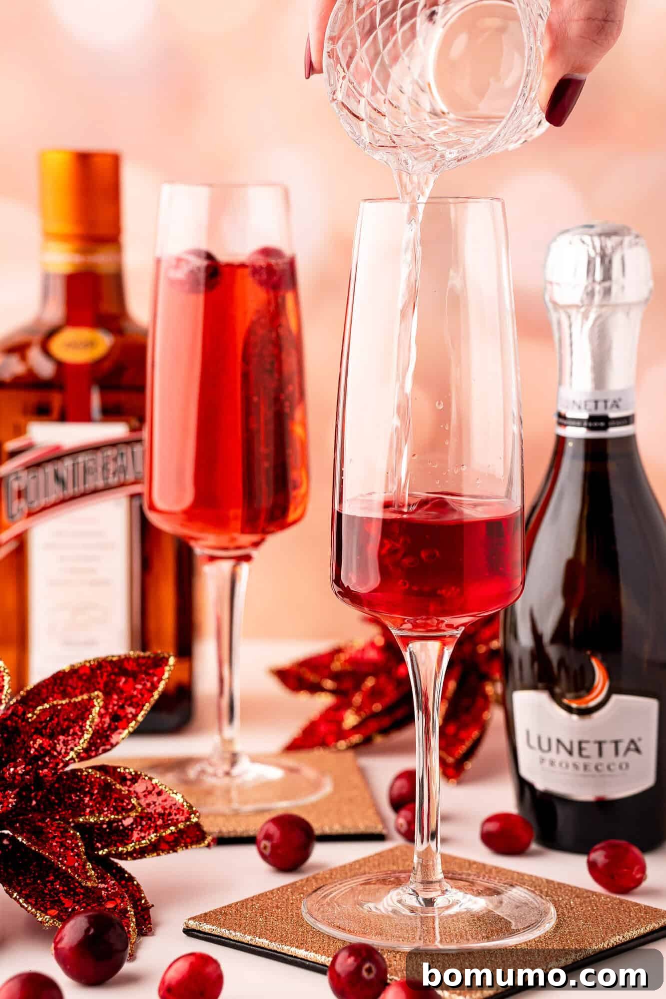 Adding Cointreau to the champagne flute.