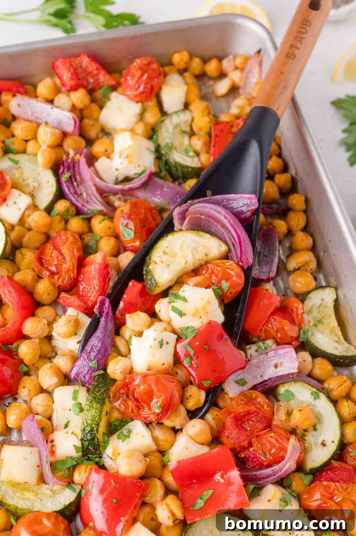Mediterranean Chickpea and Halloumi Sheet Pan Dinner: Roasted chickpeas, halloumi, cherry tomatoes, zucchini, red onion, and bell pepper.