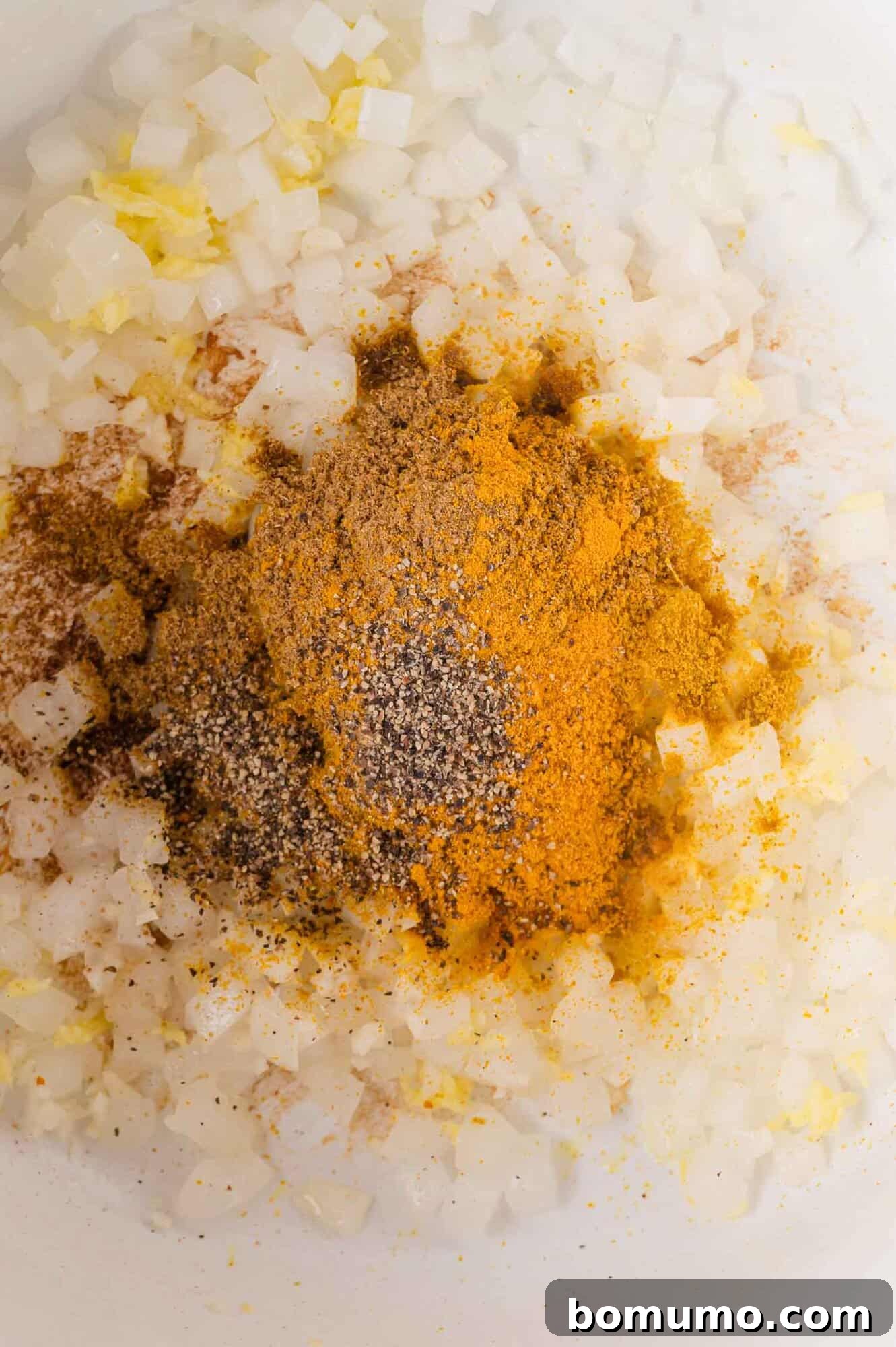 Adding spices to onions, garlic and ginger