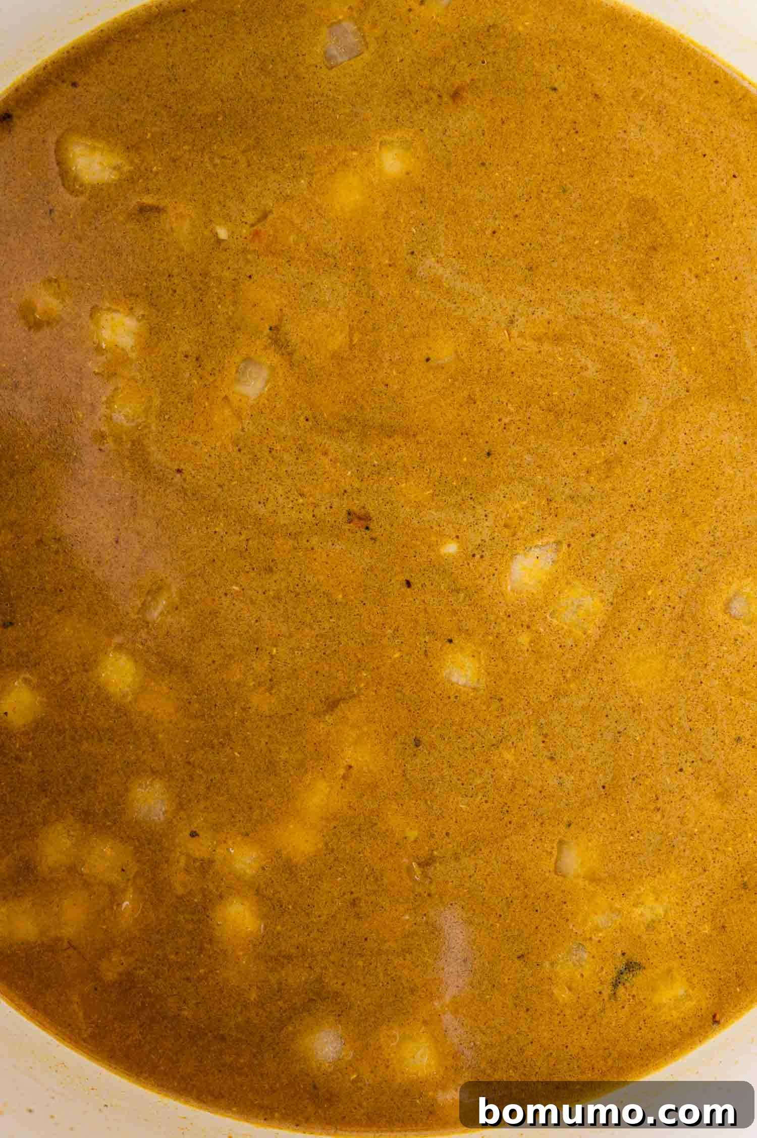 Adding vegetable broth to the pot