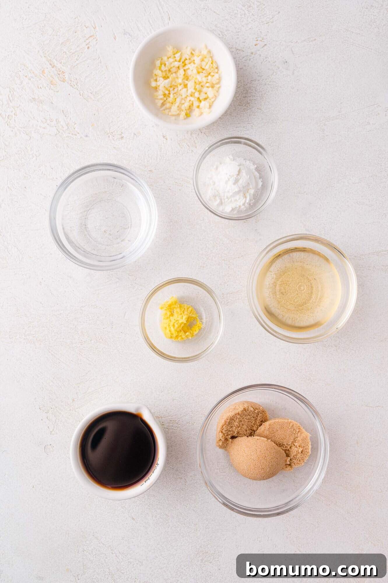 Ingredients for Teriyaki Sauce: Minced garlic, cornstarch, water, grated ginger, rice vinegar, soy sauce, and brown sugar.